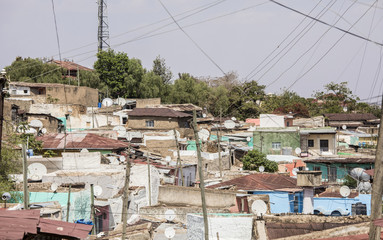 Fototapeta premium tv dishes and power lines in old town in Ethiopia