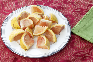 Red Grapefruit Pieces on a Round Plate