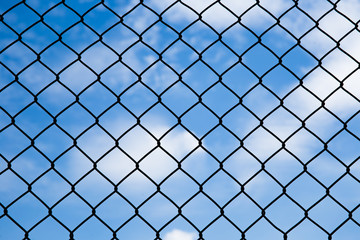 Fototapeta na wymiar Steel mesh against blue sky background