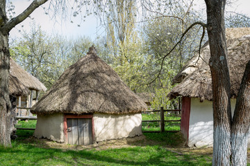 Plakat National Museum Pirogovo in the outdoors near Kiev. Ancient peasant Ukrainian house with a thatched roof, spring landscape in the old village of national architecture, Ukraine.