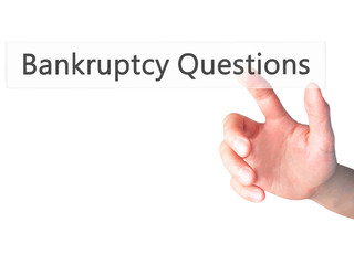 Bankruptcy Questions - Hand pressing a button on blurred background concept on visual screen.