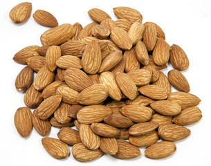 Mound of raw shelled almonds. Isolated.