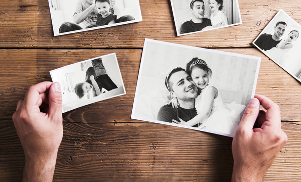 Pictures of father and daughter, wooden background. Fathers day.