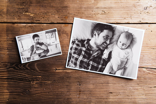 Pictures of father and baby, wooden background. Fathers day.