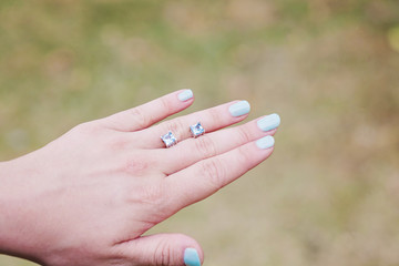 Female hand with little earrings