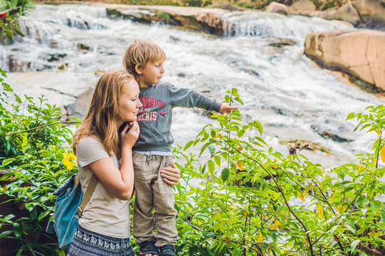 Mother and son on the background of Beautiful Camly waterfall In Da Lat city
