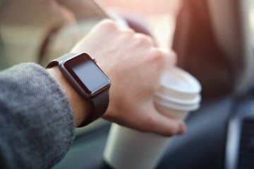 man driving a car with watch on his hand