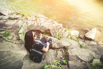Young tourist girl enjoy nature near mountain river