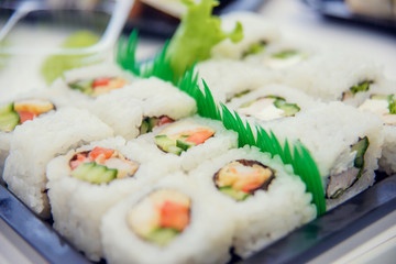Fresh and delicious maki and nigiri sushi and sake glass.