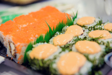 Fresh and delicious maki and nigiri sushi and sake glass.