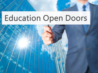Education Open Doors - Businessman hand holding sign