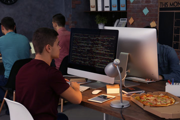 Young programmers working in office