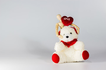 Wooden puppet hug red heart and teddy bear for valentine's day