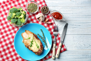 Tasty chicken parmesan with herbs on plate