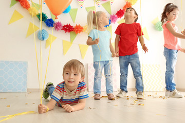 Cute little children playing at birthday party