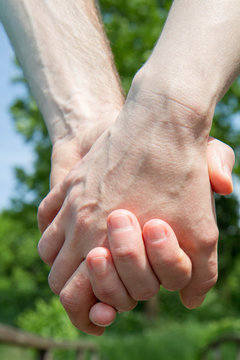 Man and woman holding hands - a close up of the hands