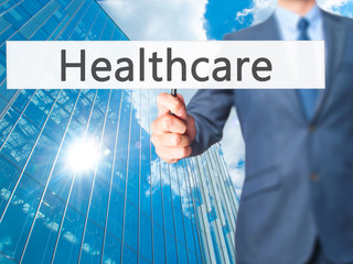 Healthcare - Businessman hand holding sign