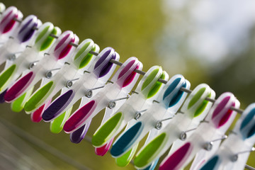 Clothespins in a row. Multicolored set outdoors.