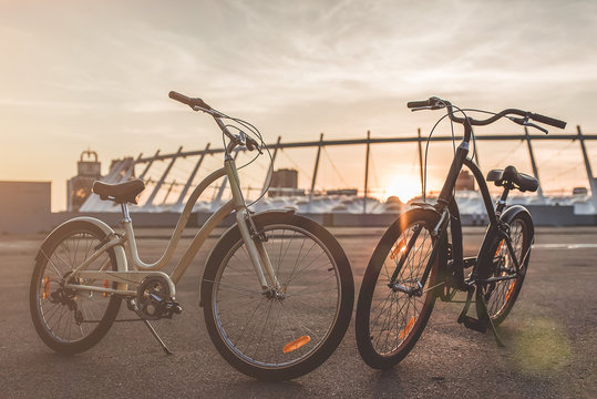 Two bicycles in the city on the sunset