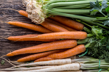 Carrot parsnip celery. Celery carrot and parsnip on rustic oak table