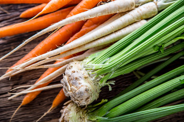 Carrot parsnip celery. Celery carrot and parsnip on rustic oak table