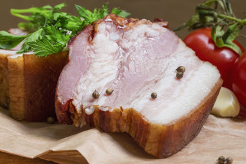 Pieces of juicy smoked boiled pork on the table close