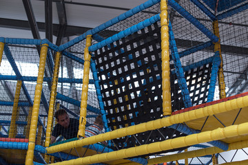 Indoor Children's Play Center. Happy kid playing with his dad