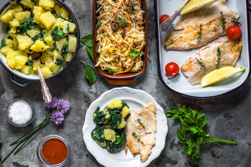 Griled fish fillet with potato and salad