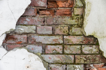 brick wall with cracked plaster