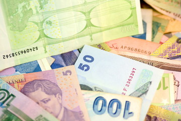 Different currency note and coins from different countries background