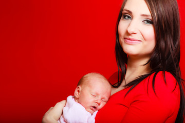 Little newborn baby sleeping on mother chest