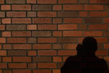 Brick wall with photographer shaddow and silhouette
