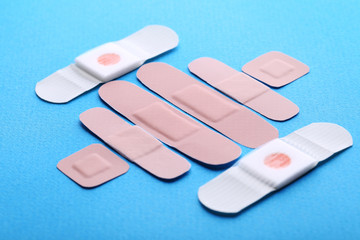 Medical plasters on blue background