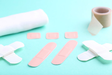 Medical plasters on mint background