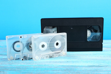 Video and music cassette tapes on wooden table