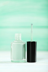 Bottle of nail polish on a wooden table