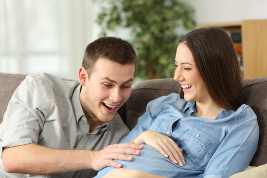 Happy husband and pregnant woman expecting birth