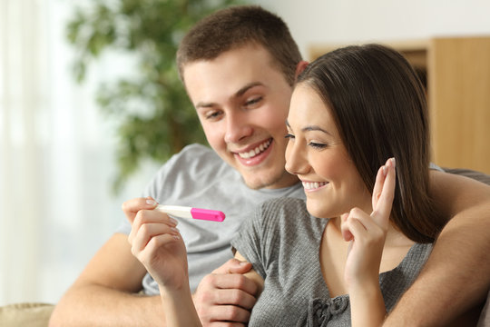 Hopeful couple checking a pregnancy test