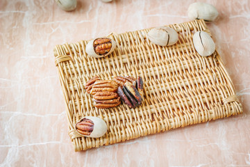 Nice pecan nuts over pink plastic board.