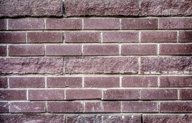 background of dark pink brick laid horizontally 
