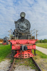 Naklejka premium Old steam locomotive train under blue sky