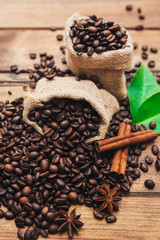Coffee beans in sack on wooden table