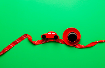 Cup of black coffee with car