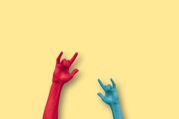 two hands doing the sign of the horns in a minimalistic background