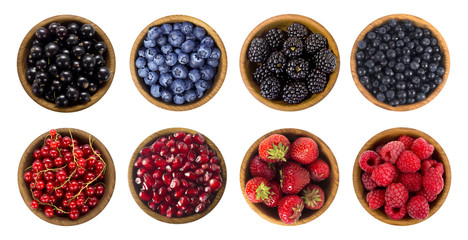 Black-blue and red berries isolated on white background. Collage of different fruits and berries. Blueberry, blackberry, cherry, strawberry, currant and raspberry. Top view.