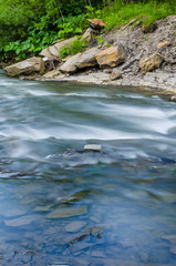 Background of Carpathian mountain river with long exposure