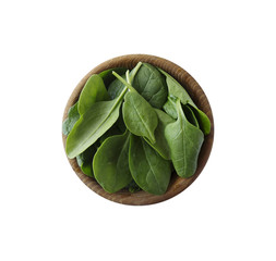 Spinach in wooden bowl. Top view. Spinach isolated on a white background. Green spinach with copy space for text.
