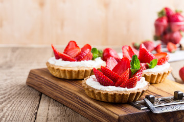 Strawberry shortcake pies on rustic wooden table