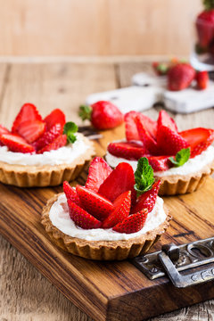 Strawberry shortcake pies on rustic wooden table