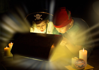 Cute girl and adventurous boy found a treasures. Happy young pirates.
